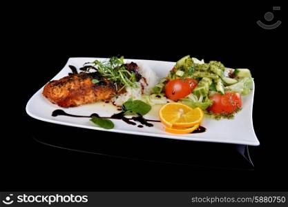 roasted fish, rice and vegetables on dish