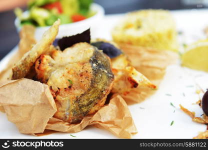 roasted fish, rice and vegetables on dish