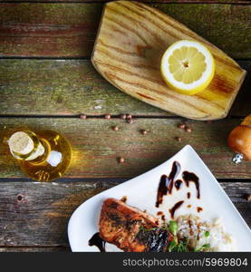 roasted fish, rice and vegetables on dish