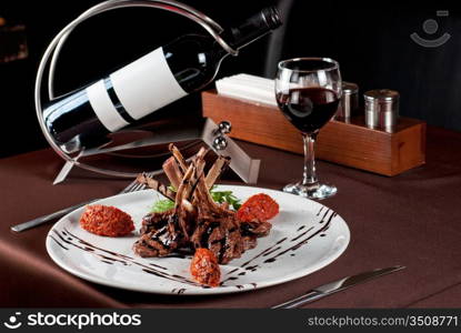 Roasted lamb chops with vegetables on decorated table