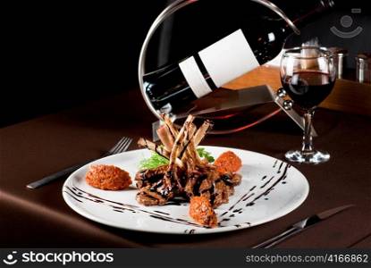 Roasted lamb chops with vegetables on decorated table