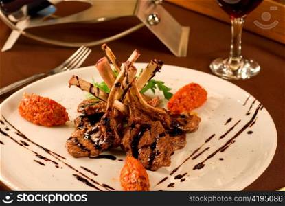 Roasted lamb chops with vegetables on decorated table