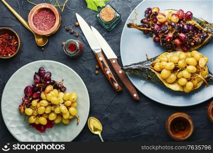 Roasted mackerel or scomber in grape berry sauce. Fish food. Baked mackerel with grapes