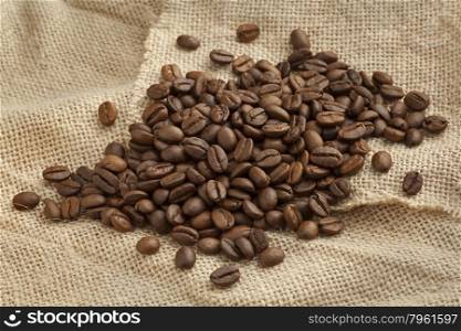 Roasted Malabar coffee beans from India on a jute bag