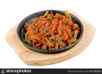 Roasted meat and vegetables at pan isolated on a white background