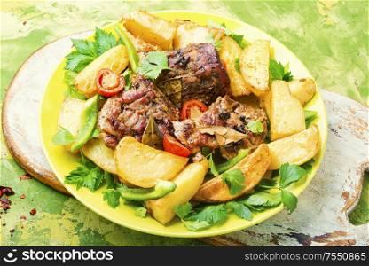 Roasted meat.Plate of grilled meat and potatoes. Baked meat with potatoes