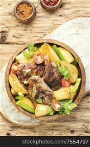 Roasted meat.Plate of grilled meat and potatoes. Baked meat with potatoes