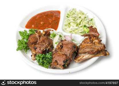 Roasted meat with sauce and vegetables isolated on white background