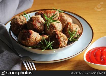 Roasted meatballs with tomato sauce , delicious meat cutlets on wooden table .. Roasted meatballs with tomato sauce , delicious meat cutlets on wooden table