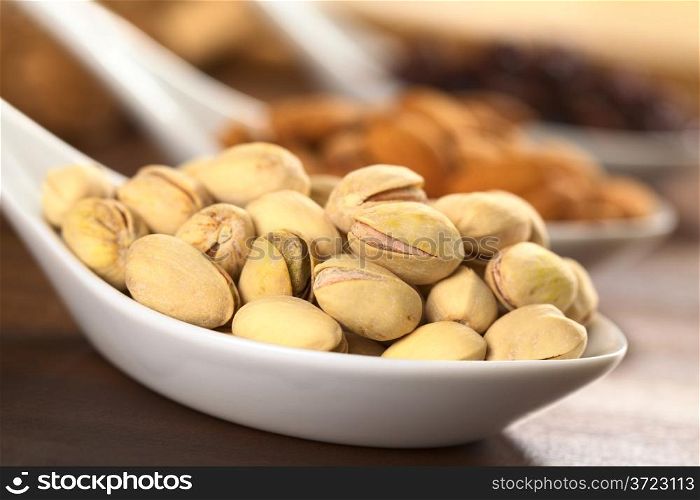 Roasted pistachio nuts with shell (Selective Focus, Focus on the upper right pistachio)