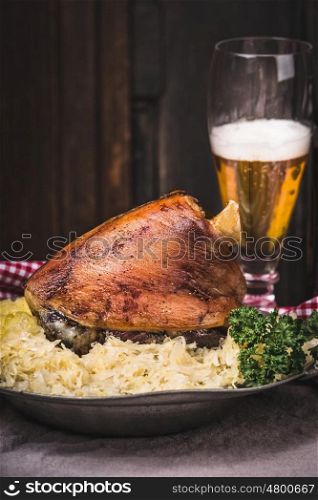 Roasted pork knuckle eisbein with braised boiled cabbage , Mashed Potatoes and beer at wooden background, front view, place for text