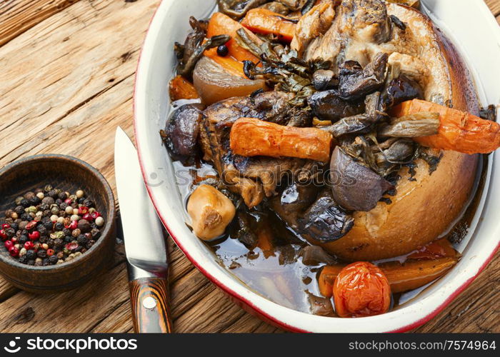 Roasted pork knuckle eisbein with vegetables on wooden background.Braised pork leg. Roasted pork knuckle