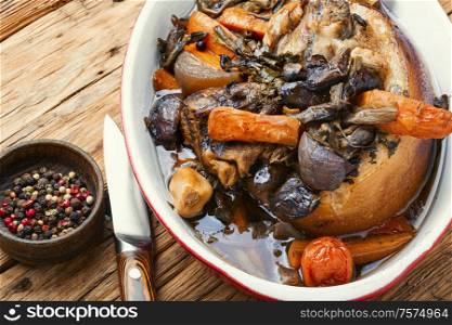 Roasted pork knuckle eisbein with vegetables on wooden background.Braised pork leg. Roasted pork knuckle