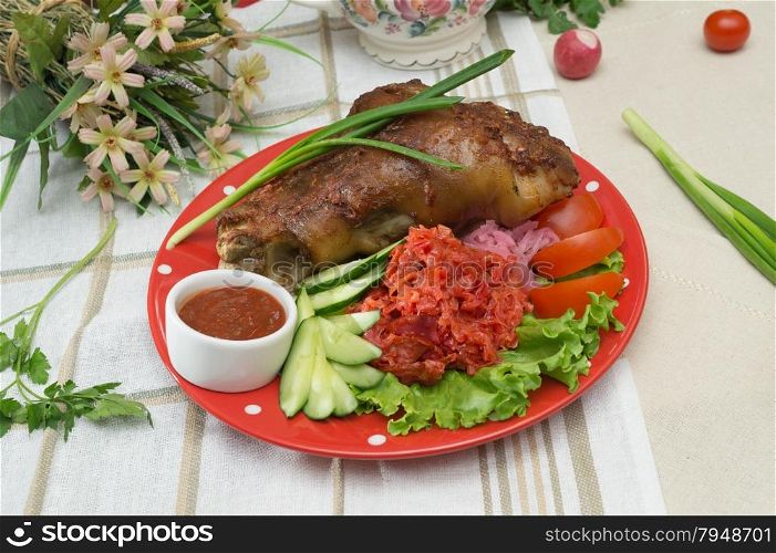 roasted pork knuckle with vegetables and herbs