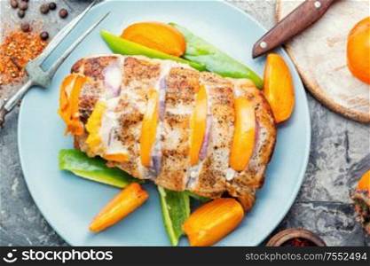 Roasted pork loin with baked persimmon.Homemade barbecue pork. Grilled barbecue pork