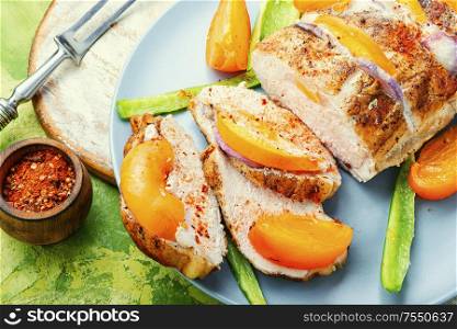 Roasted pork loin with baked persimmon.Homemade barbecue pork. Roast pork meat with persimmon