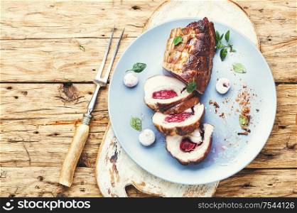 Roasted pork with cherry filling.Baked pork in a baking dish. Meat loaf with cherry