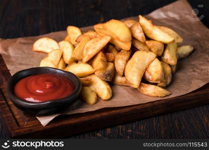 Roasted potato wedges . Roasted potato wedges on cutting board