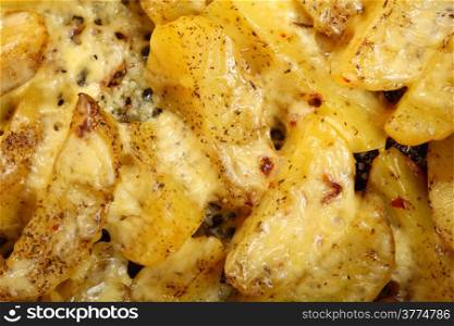 Roasted potatoes with spices and cheese as background