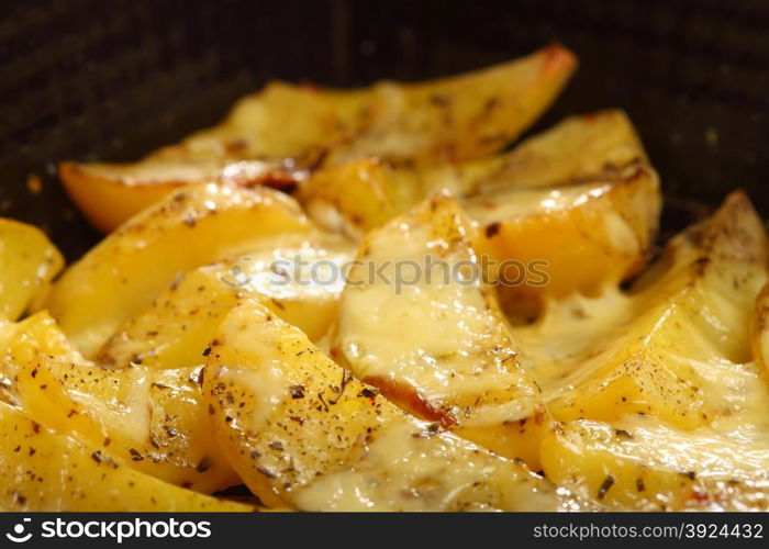 Roasted potatoes with spices and cheese as background