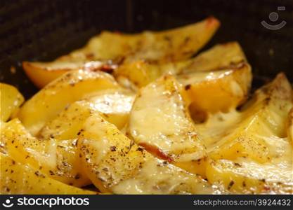 Roasted potatoes with spices and cheese as background
