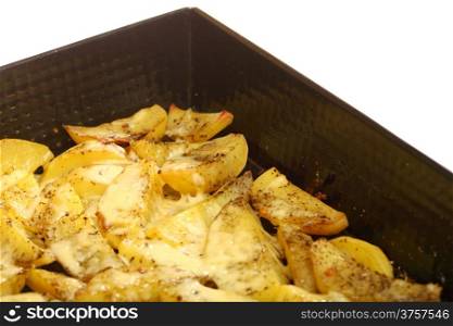 Roasted potatoes with spices and cheese in tray white background
