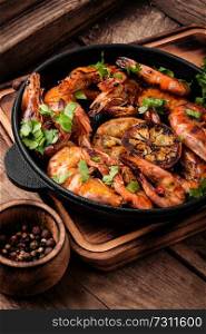 Roasted prawns on iron cast pan.Grilled seafood. Delicious roasted shrimps