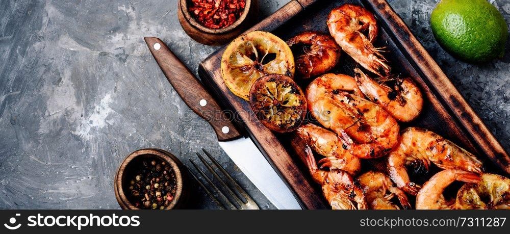Roasted prawns on wooden cutting board.Grilled seafood. Barbecue shrimps or prawns