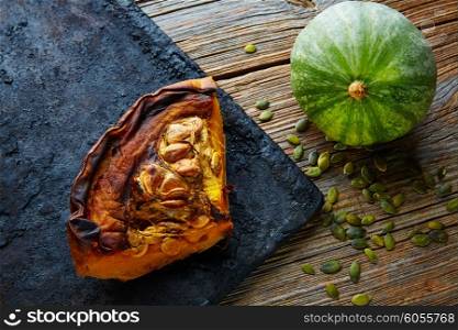 roasted pumpkin on vintage tray in wooden table background