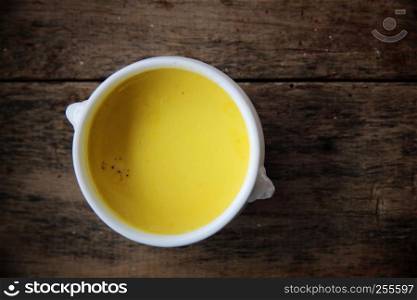 Roasted pumpkin soup on wooden background