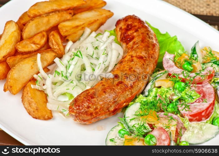 Roasted sausage. Roasted sausage with vegetables closeup