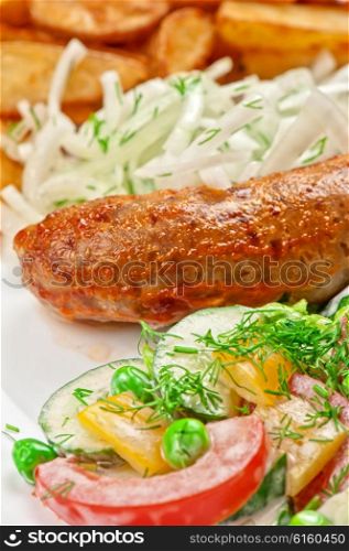 Roasted sausage with vegetables . Roasted sausage with vegetables closeup