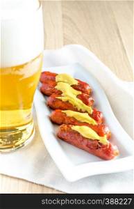 Roasted sausages with glass of beer