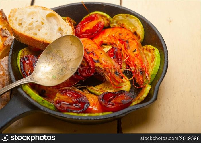 roasted shrimps on cast iron skillet with zucchini and tomatoes