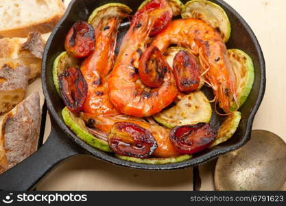 roasted shrimps on cast iron skillet with zucchini and tomatoes