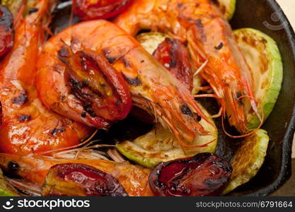 roasted shrimps on cast iron skillet with zucchini and tomatoes