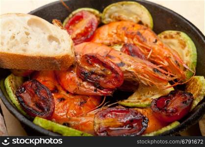 roasted shrimps on cast iron skillet with zucchini and tomatoes