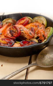 roasted shrimps on cast iron skillet with zucchini and tomatoes