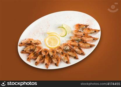 roasted shrimps with lemon isolated on a white background