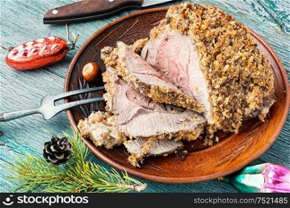 Roasted sliced Christmas ham.Roasted beef on plate. Baked meat on festive table