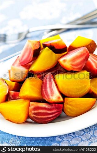 Roasted sliced red and golden beets on a plate