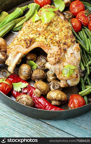 Roasted turkey with grilled vegetables on wooden table. Turkey with roasted vegetables.