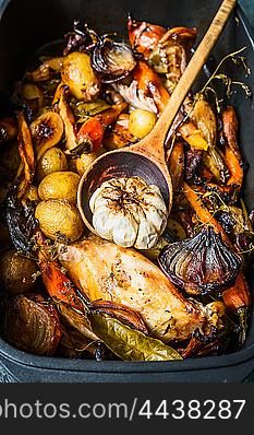 Roasted Vegetables chicken stew or ragout with wooden spoon, close up