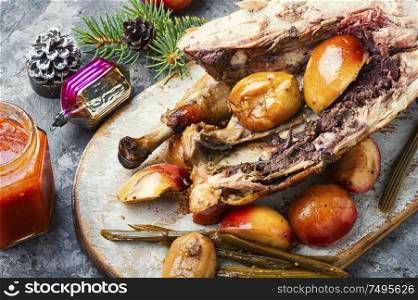 Roasted whole chicken stuffed with apples and Christmas decoration. Traditional christmas chicken