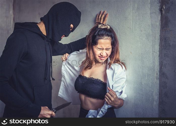 Robber or thief force woman to take off her clothes and raping in abandoned house. Criminal sexual and illegal violence crisis concept. Social issues and problem concept
