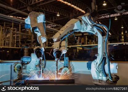Robot is welding steel part in factory