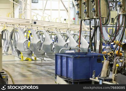 robotic arm and spare parts in a car factory. spare parts in a car factory