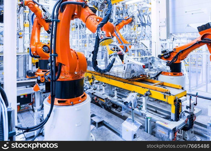 robotic arms in a car plant. robots in a car factory