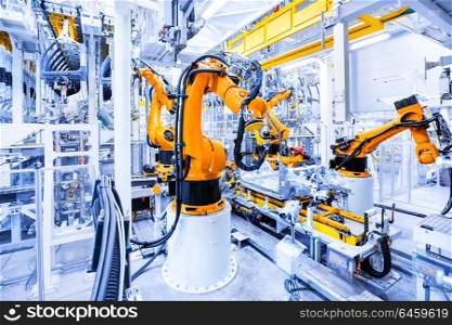 robots in a car plant. robotic arms in a car plant