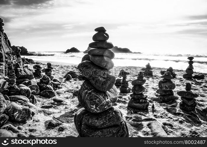 rock balancing at the beach in black and white